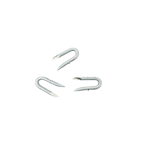 Three metal barbed staples on a white background