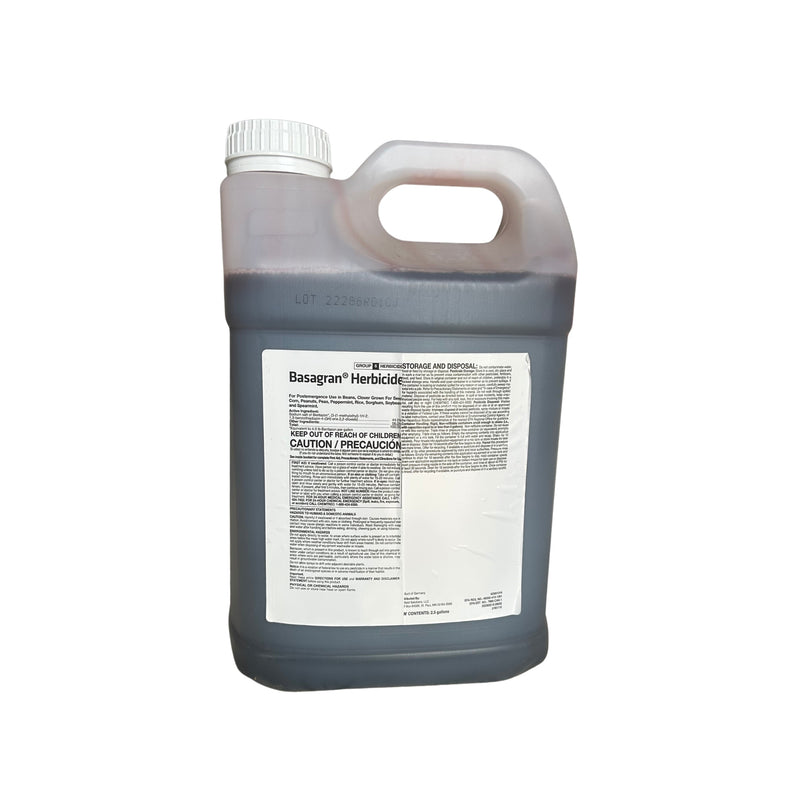 a clear jug containing a purple liquid with a label against a white background