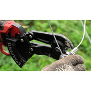 Strainrite crimping tool being used on a wire with a gloved hand against a green background