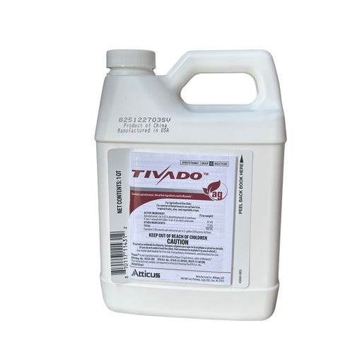 A white jug with a red and black label against a white background